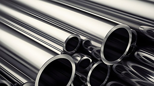 A stack of stainless steel pipes with the word steel