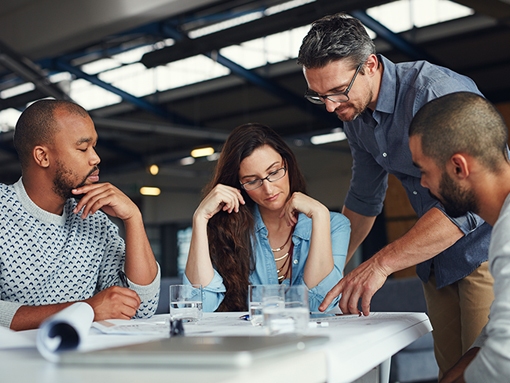 K-Tube engineers working on project schematics